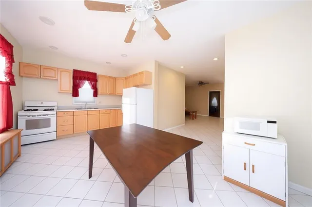 a kitchen with stainless steel appliances granite countertop a sink refrigerator and cabinets