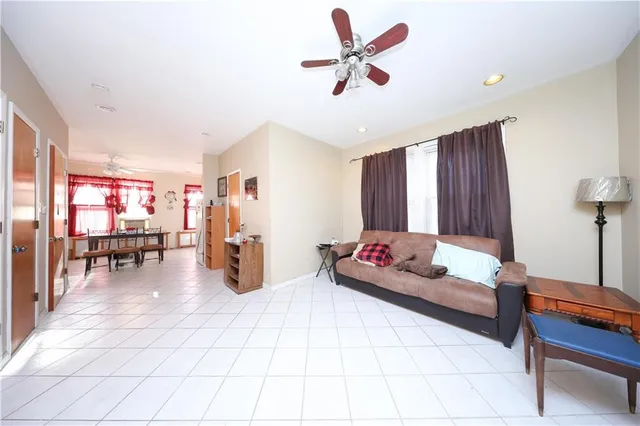 a living room with furniture and kitchen view