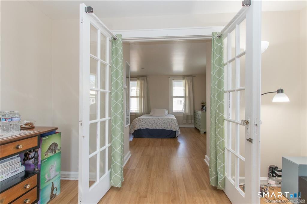 18 Lawrence Street Norwalk, CT 06854 - Photo 14 of 31 a spacious bedroom with a bed and a mirror