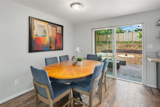 a dining room with furniture and wooden floor