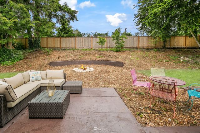 a view of a backyard with sitting area