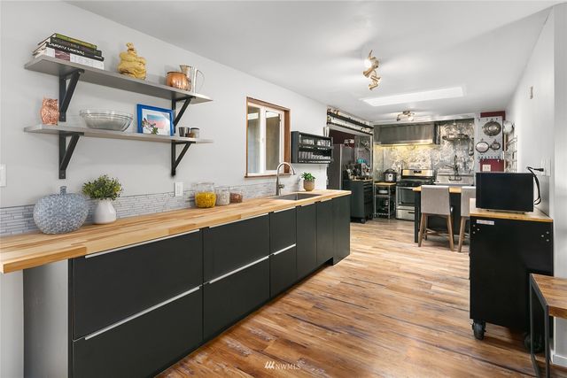 a kitchen with cabinets and wooden floor