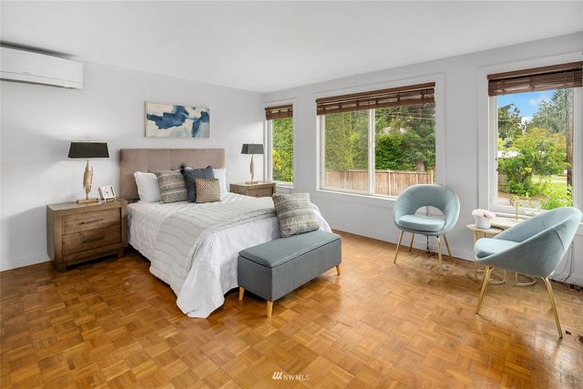 a spacious bedroom with a bed and a large window