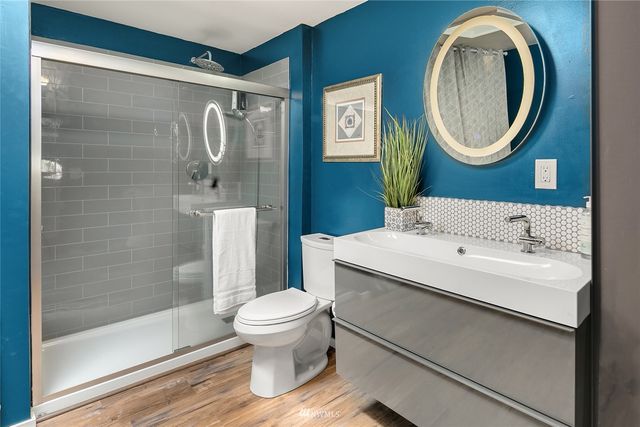 a bathroom with a sink toilet and shower