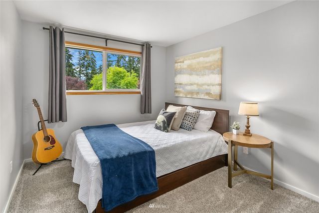 a bedroom with a bed and window