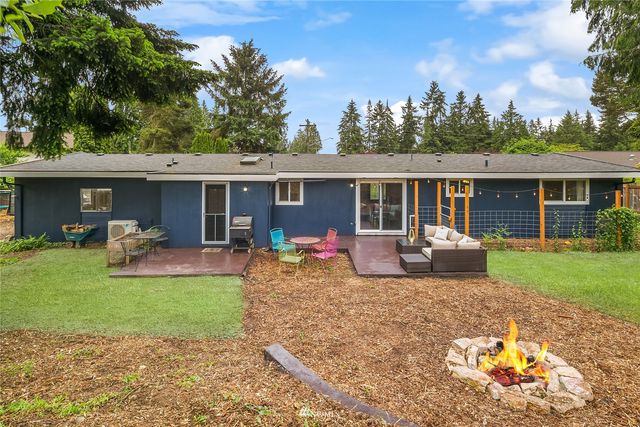a view of a house with a backyard porch and furniture