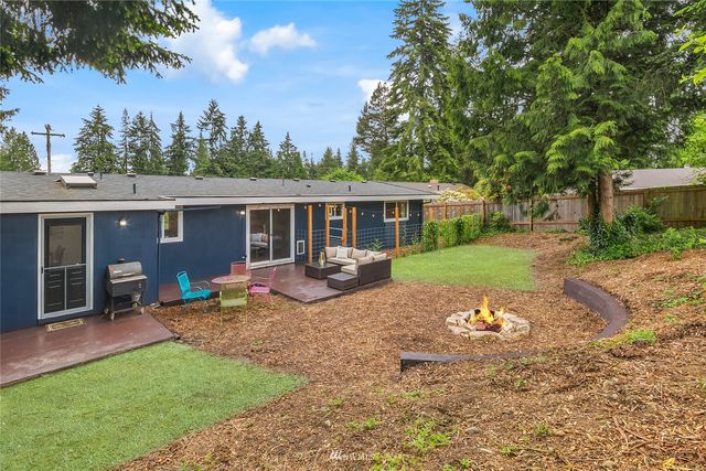a view of a house with a yard and sitting area