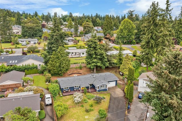 an aerial view of residential houses with outdoor space and street view