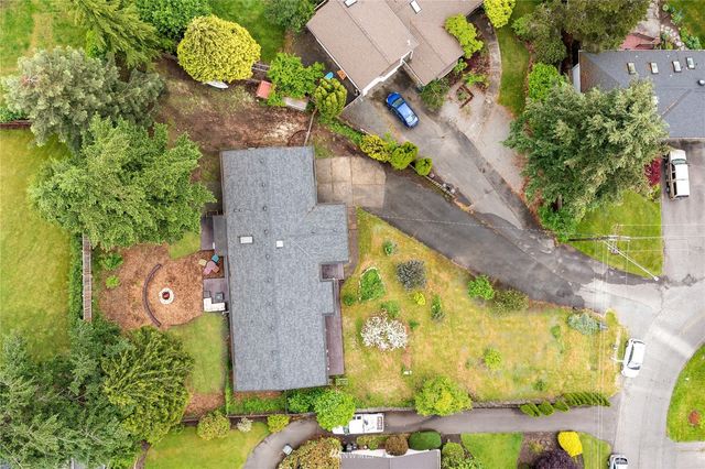 an aerial view of a house with a yard pool patio and outdoor seating