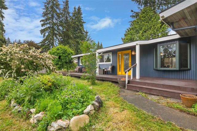 a view of house with backyard outdoor seating and green space