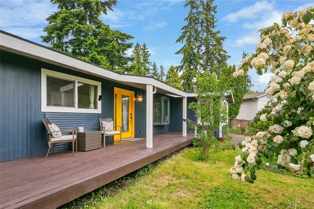 a view of house with backyard outdoor seating and green space
