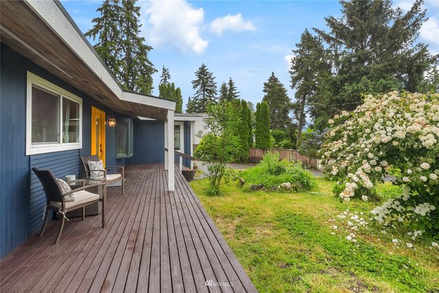 a view of house with backyard outdoor seating and green space