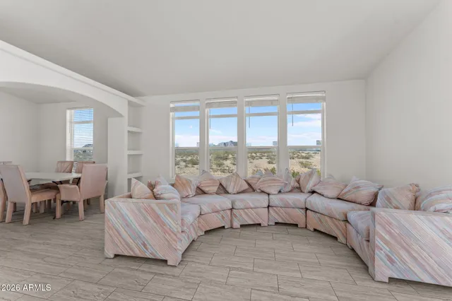 a living room with furniture and a large window with outer view