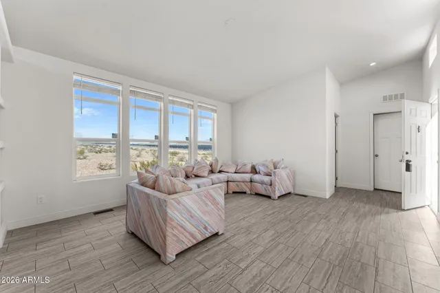 a living room with furniture and large windows