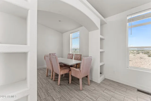 a dining room with furniture and window