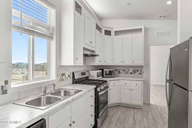 a kitchen with a sink stove and refrigerator