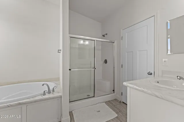 a bathroom with a granite countertop sink a toilet and shower