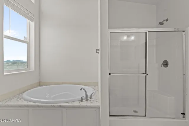 a bathroom with a tub and shower