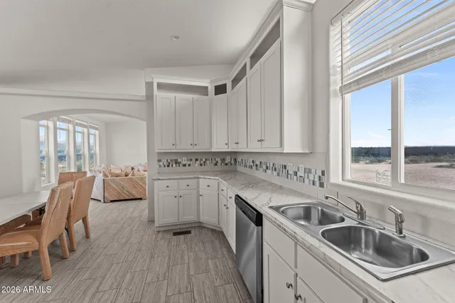 a kitchen that has a sink and cabinets