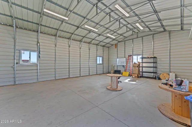 a view of a house with backyard and trees