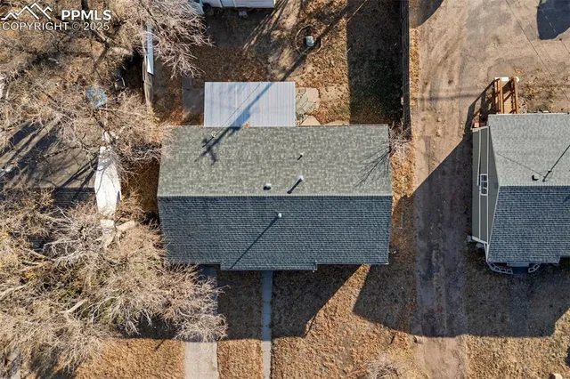 a view of house with a tree beside it