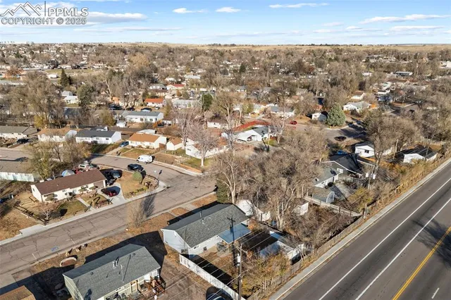 an aerial view of residential houses with outdoor space