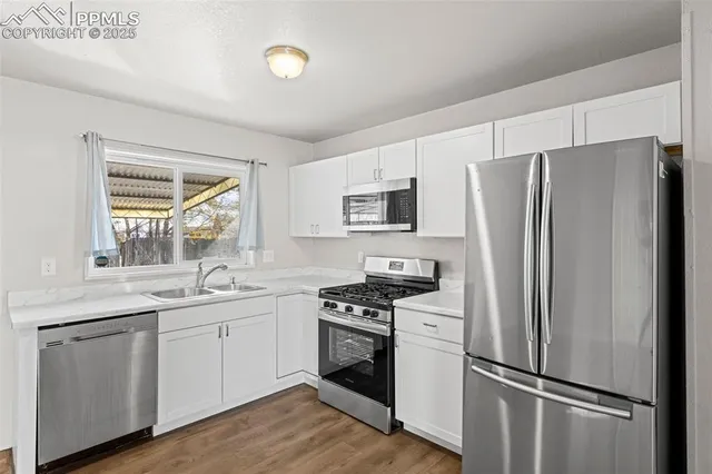 a kitchen with a refrigerator sink and microwave