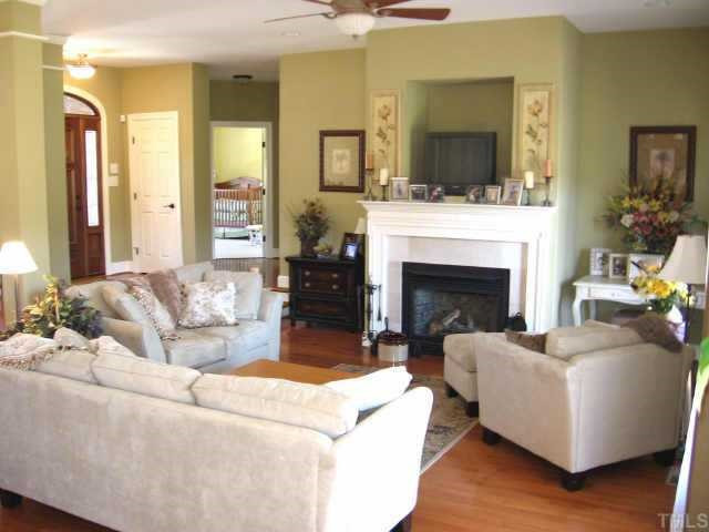 3320 La Costa Way Raleigh, NC 27610 - Photo 2 of 10 The sunken family room is the heartbeat of this home! Complete with french doors to the deck, a gas log fireplace & built in shelving! Maple floors with a cinammon stain give a warm & cozy feeling! Other