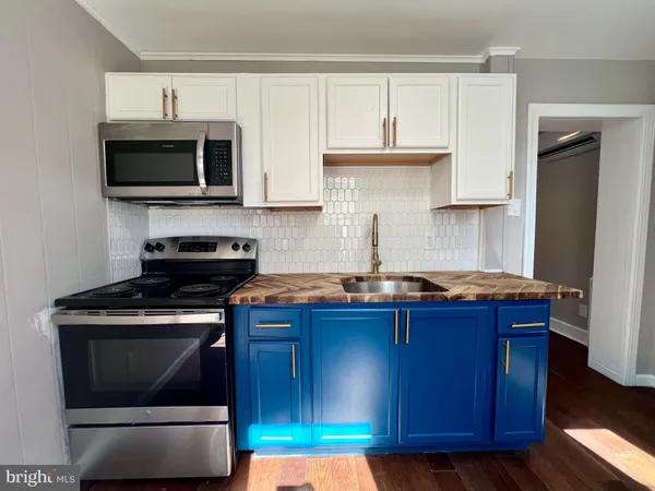 a kitchen with stainless steel appliances a stove a microwave and cabinets