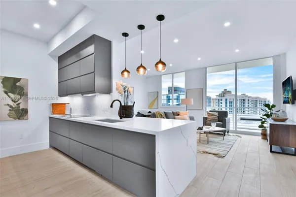 a metallic refrigerator freezer and a refrigerator in a kitchen