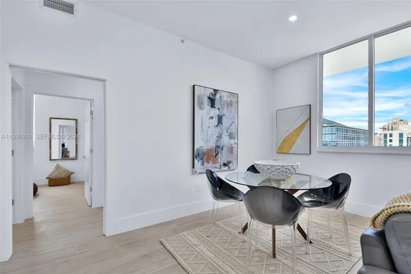 a living room with furniture and potted plant