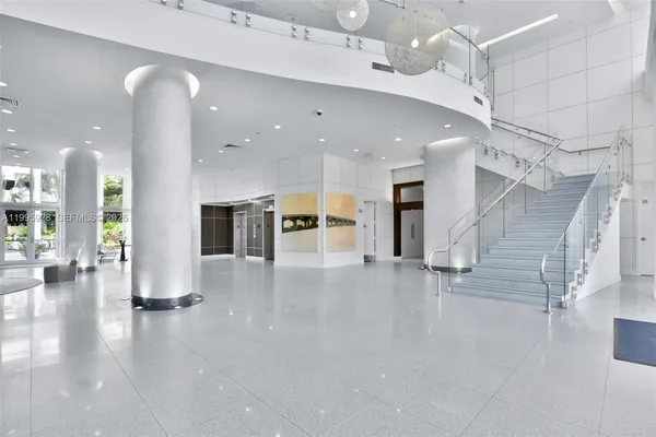 a view of living room with furniture and wooden floor