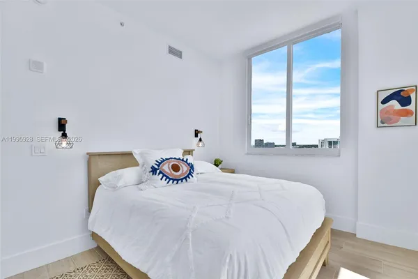 a bedroom with a bed and a chair