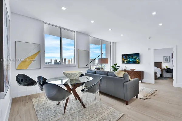 a kitchen with stainless steel appliances granite countertop a sink a refrigerator and a stove