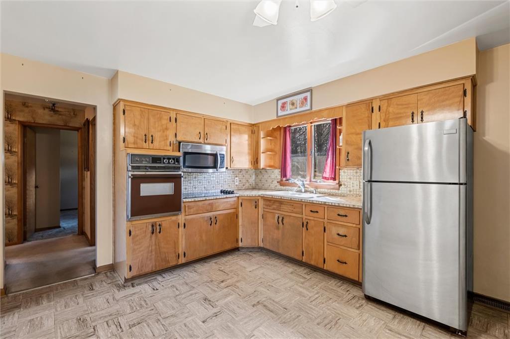 865 Wheatland Road West Middlesex, PA 16159 - Photo 4 of 24 a kitchen with granite countertop cabinets stainless steel appliances and a counter space