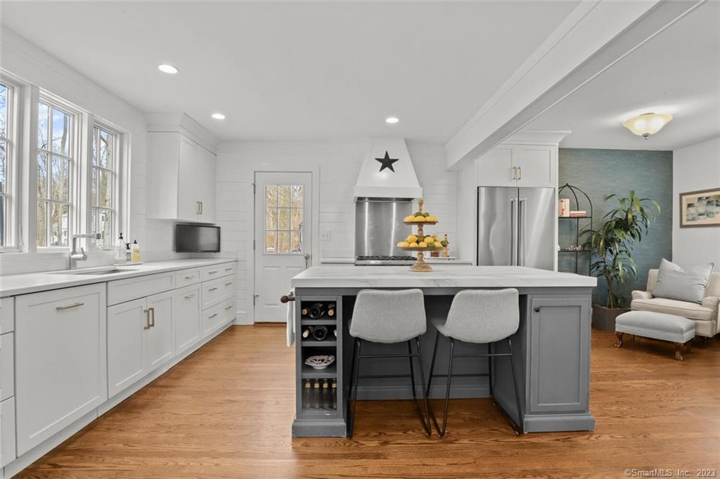 183 Frogtown Road New Canaan, CT 06840 - Photo 11 of 37 a large kitchen with a table and chairs in it