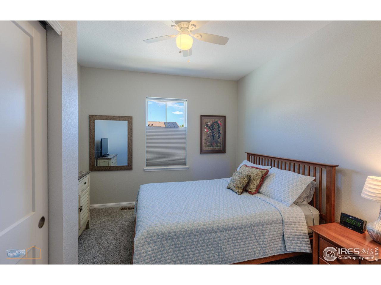 12908 Sandstone Drive Broomfield, CO 80021 - Photo 21 of 39 a bedroom with a bed and lamps
