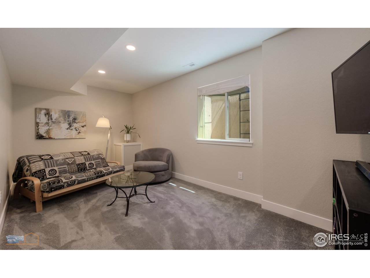 12908 Sandstone Drive Broomfield, CO 80021 - Photo 23 of 39 a living room with furniture and a flat screen tv