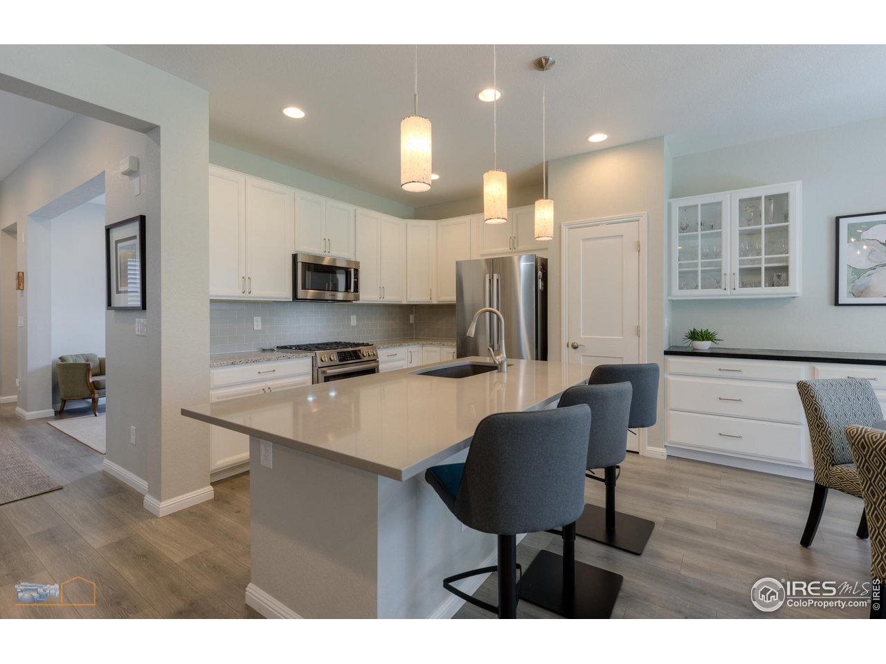 12908 Sandstone Drive Broomfield, CO 80021 - Photo 5 of 39 a kitchen with stainless steel appliances kitchen island granite countertop a sink and cabinets