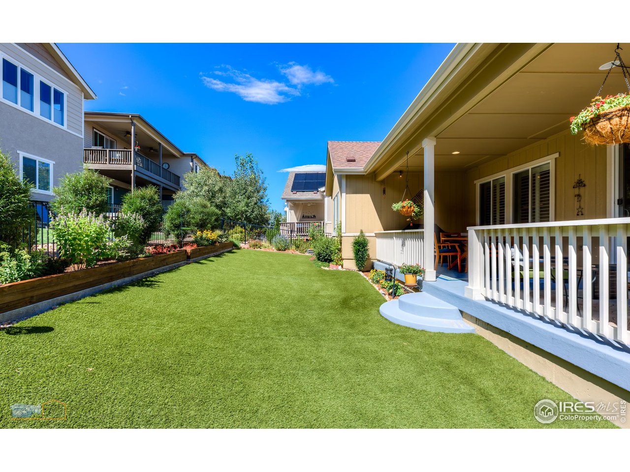 12908 Sandstone Drive Broomfield, CO 80021 - Photo 10 of 39 a backyard of a house with wooden floor and fence