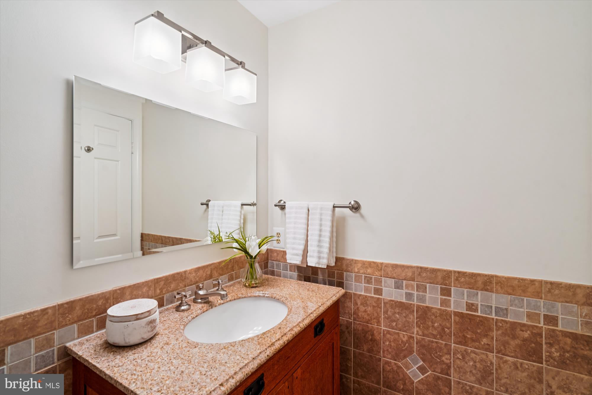 7252 Evans Mill Road McLean, VA 22101 - Photo 35 of 89 a bathroom with a granite countertop sink and a mirror