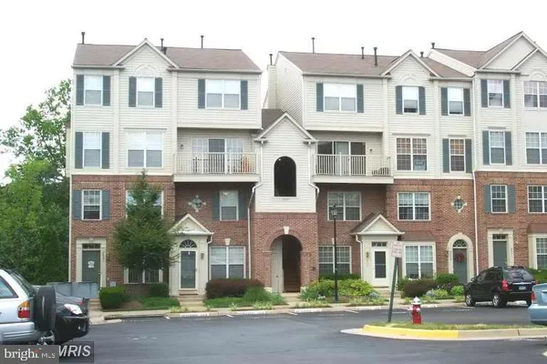 a front view of a residential apartment building with a yard