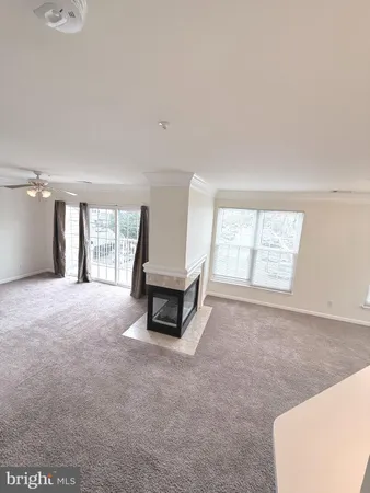 a big room with windows and a fireplace