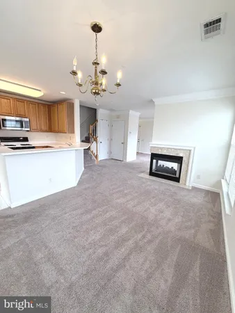 a view of a kitchen with a sink and a chandelier