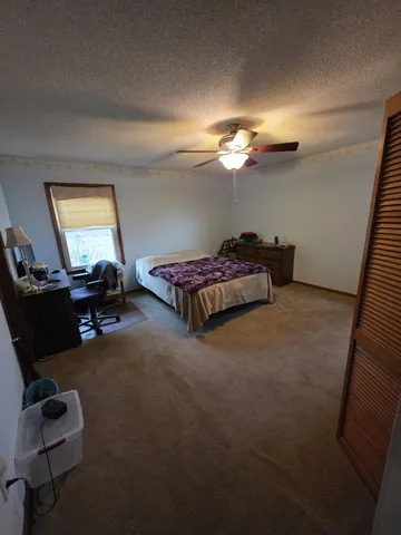 a living room with furniture a lamp and a window