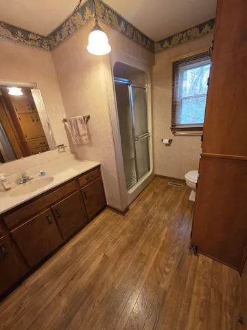 a bedroom with a bed and a mirror on the dresser