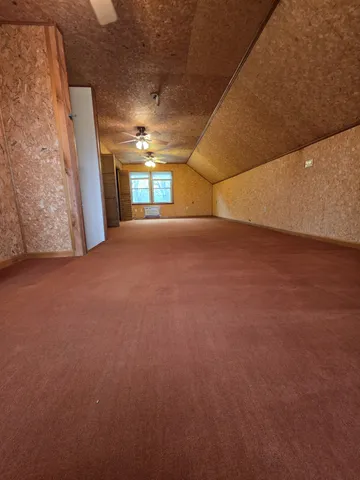 a view of empty room with window and stairs