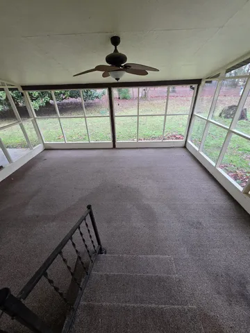 a view of room with window and a ceiling fan