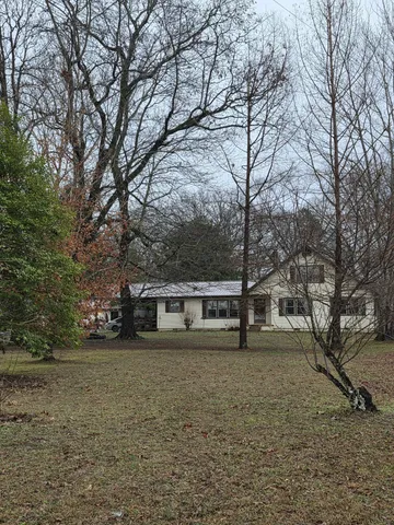 a view of house with trees in front of it