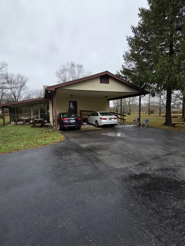 a view of a yard with cars